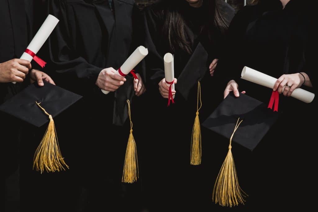 four-grad-students-caps-and-diplomas (1)